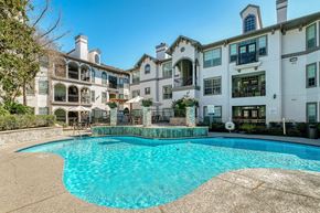 Houston apartment for rent - a swimming pool in front of an apartment building with a pool