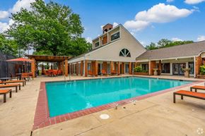 Cordova apartment for rent - a swimming pool in front of a house with a resort style pool