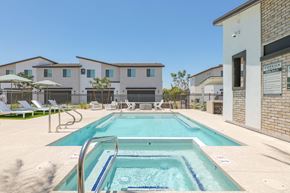 Phoenix apartment for rent - A pool in front of a building with a sign that says "Corsica".