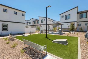 Phoenix apartment for rent - A white building with a black roof and a green lawn in front.