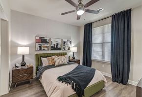 San Antonio apartment for rent - A bedroom with a bed, nightstands, and a ceiling fan.