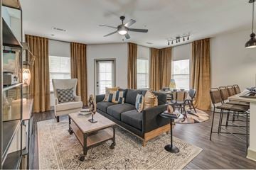 Fort Worth apartment for rent - A living room with a black sofa and a wooden coffee table.