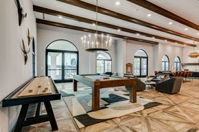 Fort Worth apartment for rent - A billiard table is in the middle of a room with a pool table.