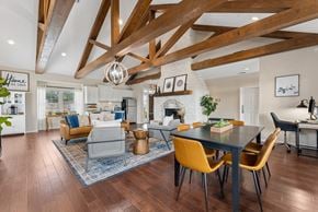 New Braunfels apartment for rent - A modern dining room with a black table and yellow chairs.