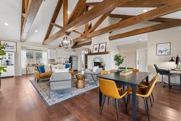 New Braunfels apartment for rent - A modern dining room with a black table and yellow chairs.