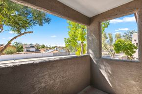 Glendale apartment for rent - a large window on a balcony with a view of trees and houses