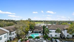Apopka apartment for rent - an aerial view of a neighborhood with a swimming pool and houses