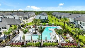 Fort Myers townhouse for rent - an aerial view of a swimming pool surrounded by apartment buildings