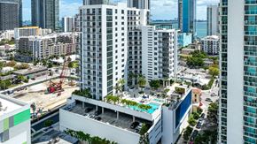 Miami apartment for rent - an aerial view of a city with tall buildings and a pool