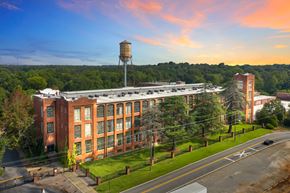 Spartanburg apartment for rent - an aerial view of an old brick building with a water tower