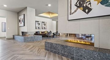Austin apartment for rent - A modern living room with a fireplace and a painting on the wall.
