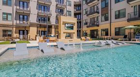 Austin apartment for rent - A swimming pool in front of apartment buildings.