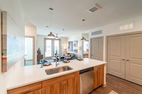 Georgetown apartment for rent - A kitchen with a white counter top and wooden cabinets.
