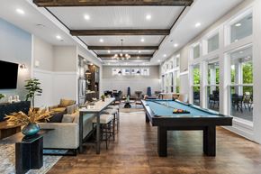 Antioch apartment for rent - A pool table is in the middle of a room with a bar and a TV.
