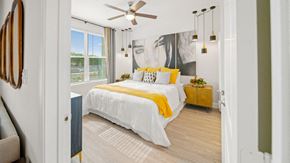 Hutto apartment for rent - a bedroom with a bed and a ceiling fan