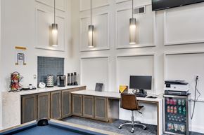 Cincinnati apartment for rent - A modern office with a pool table and a desk with a computer.