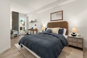 San Diego apartment for rent - A bedroom with a large bed and a mirror on the wall.