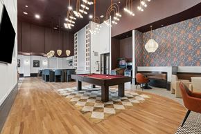 Denver apartment for rent - A room with a pool table and a checkered floor.