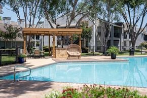 Houston apartment for rent - A pool with a bench and a canopy.