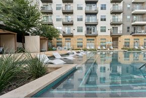 San Antonio apartment for rent - A large swimming pool in front of apartment buildings.
