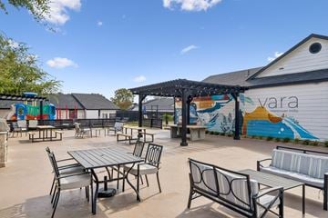 San Antonio apartment for rent - A patio with a table and chairs and a mural on the wall.