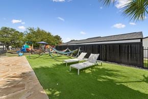 San Antonio apartment for rent - A backyard with a white lawn chair and a playground.