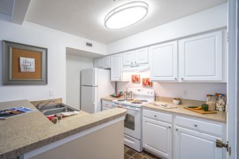 White shaker cabinetry with brushed nickel accents
