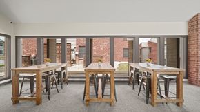Temple apartment for rent - a large open room with tables and chairs and a brick building in the background