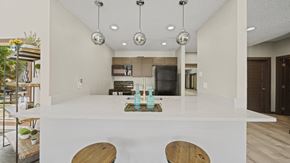Temple apartment for rent - a kitchen with white countertops and a large island