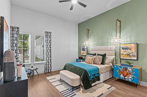 Austin apartment for rent - a bedroom with green walls and a bed