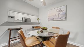 Round Rock apartment for rent - a dining area with a glass table and four chairs