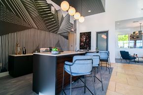 Austin apartment for rent - the kitchen and dining area of a modern house with blue chairs