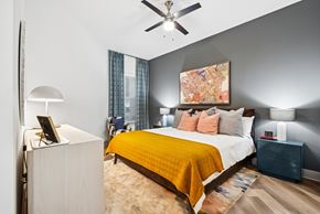 Richardson apartment for rent - A bedroom with a bed, nightstand, and lamp.