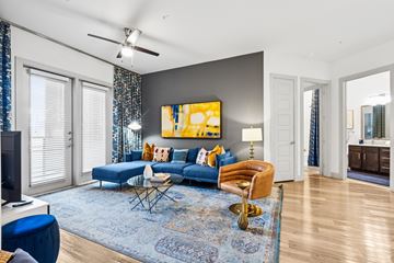 Richardson apartment for rent - A living room with a blue couch and a yellow chair.