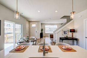 Brighton townhouse for rent - A modern dining room with a long table set for a meal.