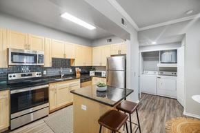Arlington apartment for rent - A kitchen with wooden cabinets and black countertops.