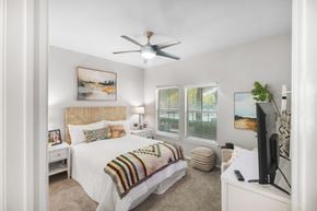 Arlington apartment for rent - A bedroom with a bed, a ceiling fan, and a television.