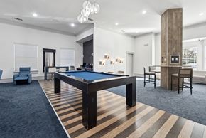 Carrollton apartment for rent - A room with a pool table and a striped carpet.