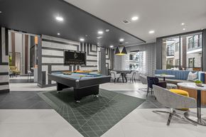 The Colony apartment for rent - A billiard table is in the middle of a room with a pool table.
