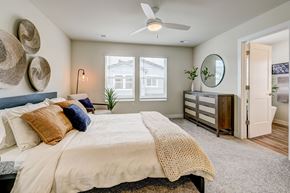 Castle Rock townhouse for rent - A bedroom with a large bed and a ceiling fan.