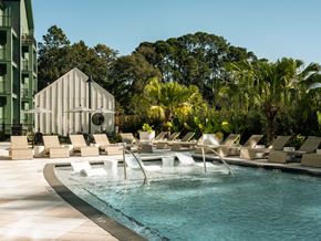 Savannah apartment for rent - A pool with a waterfall and lounge chairs.