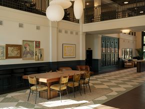 Savannah apartment for rent - A large dining room with a checkered floor and a long table with chairs.