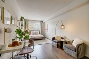 Tempe apartment for rent - A well-lit, modern bedroom with a large bed and a comfortable seating area.