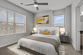 Nashville apartment for rent - A bedroom with a large bed and a ceiling fan.