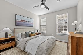 Spring Hill apartment for rent - A bedroom with a large bed and a painting on the wall.