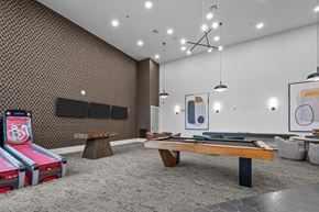 Farmers Branch apartment for rent - two pool tables in a room with televisions and other gaming equipment
