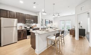 Hutto apartment for rent - A kitchen with wooden cabinetry and granite countertops