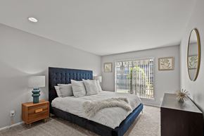 Dallas apartment for rent - a bedroom with a large bed and a window