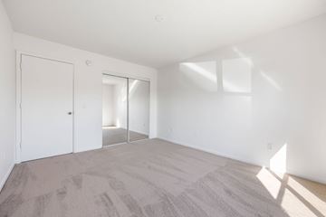 Palm Bay apartment for rent - a living room with white walls and carpet and a door to a closet
