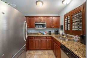 Port Saint Lucie apartment for rent - a kitchen with wooden cabinets and granite countertops